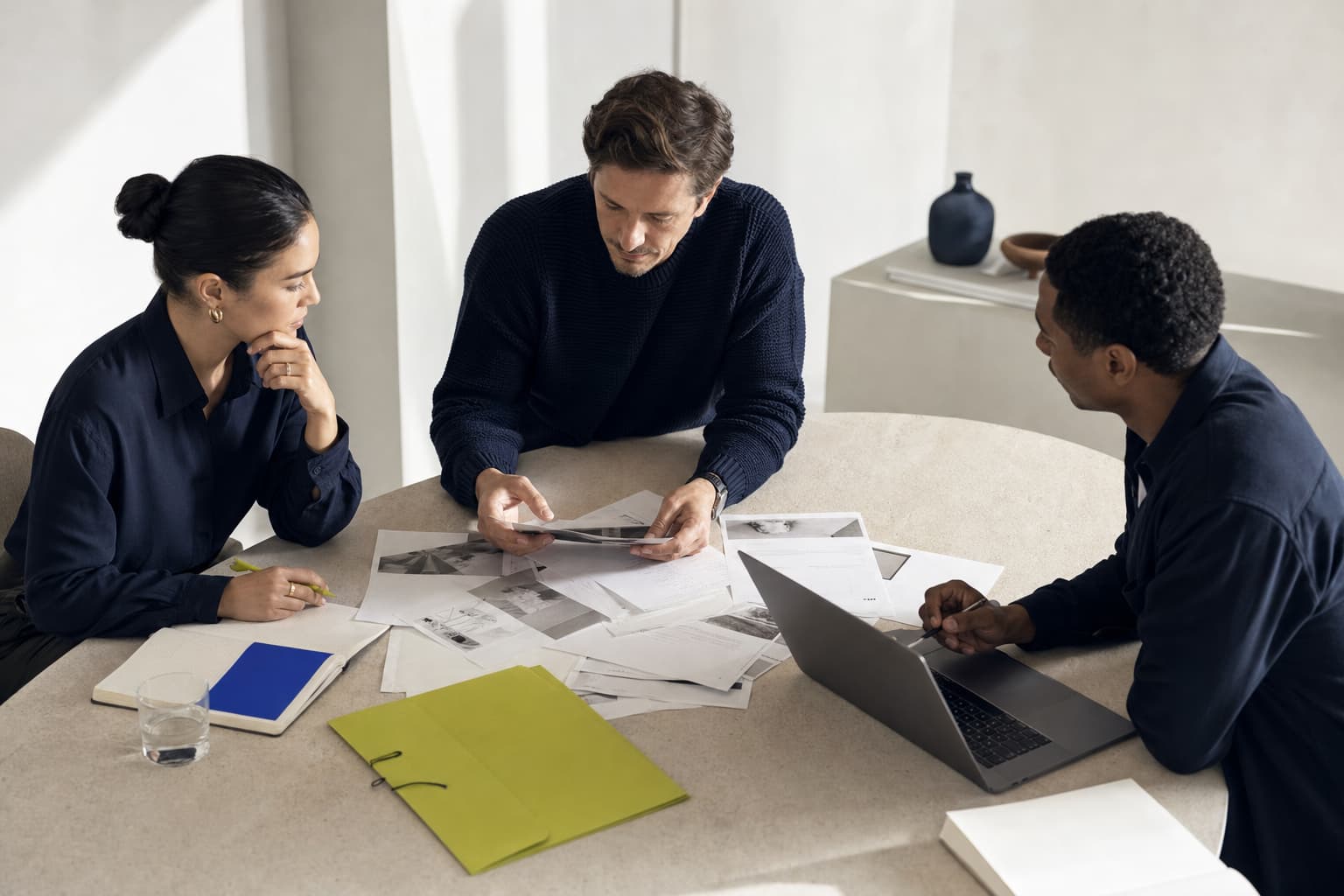 A small sales team reviewing prospect notes together